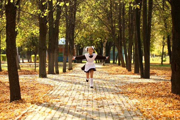 Happy little schoolgirl go home from school — Stock Photo, Image