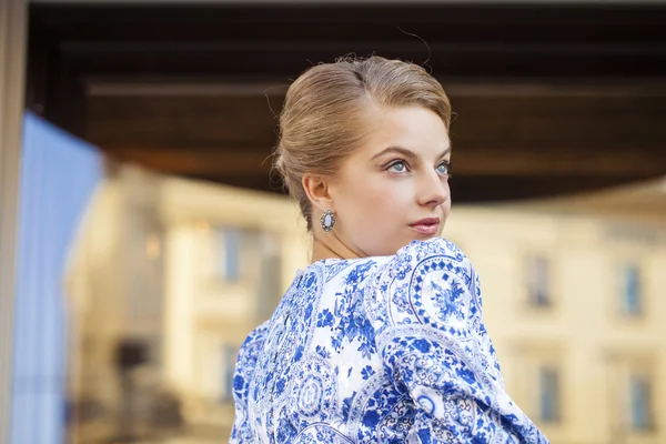 Portrait of young blonde woman in blue dress — Stock Photo, Image