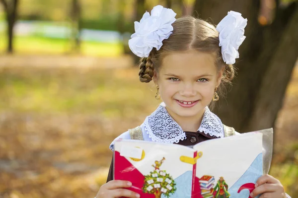 Portrait of a beautiful young first-grader in a festive school u — Stock Photo, Image