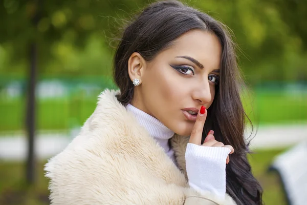 Portrait of attractive young arabic woman with finger on lips — Stock Photo, Image