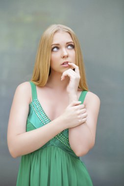 Young beautiful blonde woman thinking about something clipart