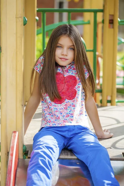 Красива маленька дівчинка на зеленому тлі літнього міського парку — стокове фото
