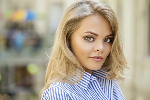 Retrato de una hermosa rubia con una camisa de rayas azules — Foto de Stock