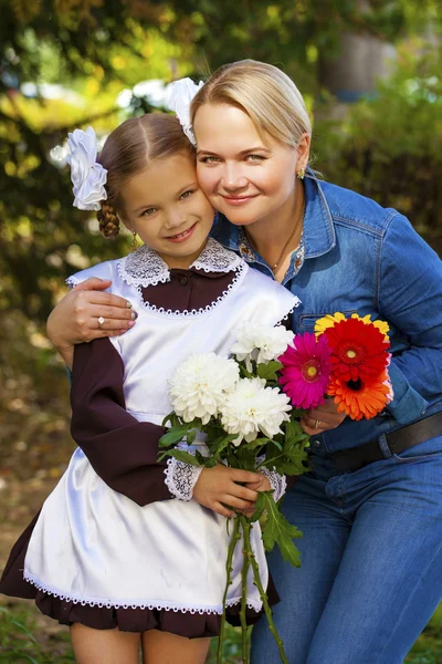 Portrait of a beautiful young first-grader in a festive school u — Stock Photo, Image