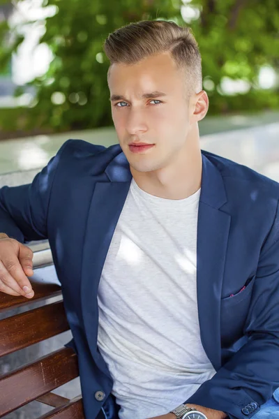 Calm handsome man on the background of summer street — Stock Photo, Image