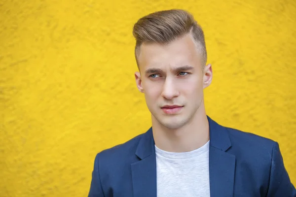 Calm handsome man on the background of summer street — Stock Photo, Image