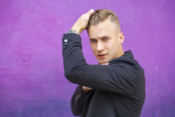 Calm handsome man on the background of summer street — Stock Photo, Image