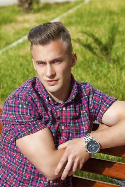 Calm handsome man on the background of summer street — Stock Photo, Image