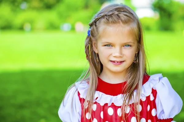 Portrait of a charming little girl looking at camera — Stock Photo, Image