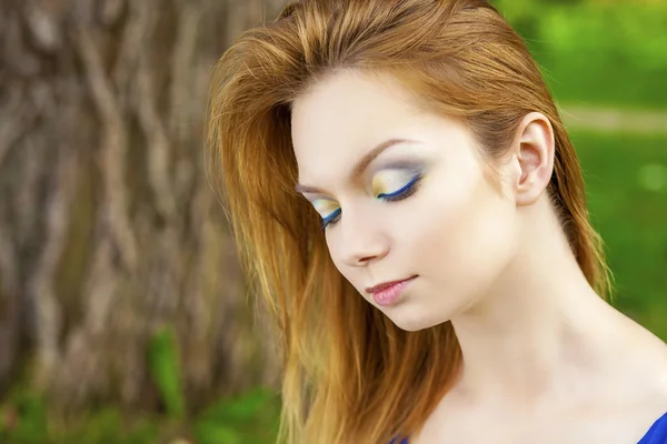 Beautiful young woman in colorful dress — Stock Photo, Image