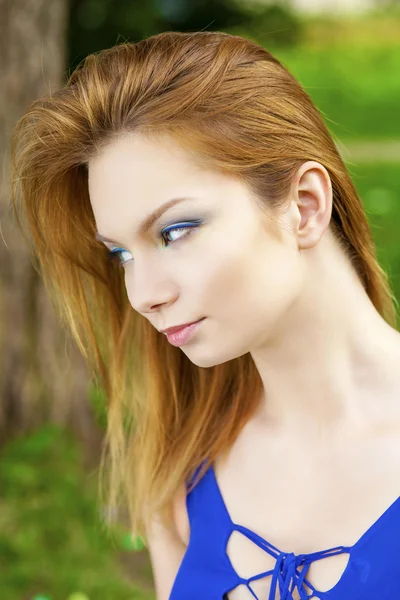 Beautiful young woman in colorful dress — Stock Photo, Image