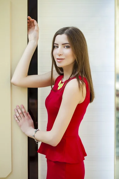 Sultry portrait of sexy brunette in a red dress — Stock Photo, Image