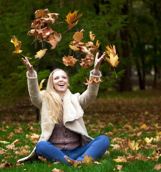 Unga glada blonda kvinnan i höst park — Stockfoto