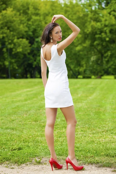 Happy young model in white sexy dress — Stock Photo, Image