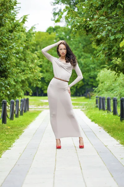 Full growth, beautiful young woman in sexy long gray dress — Stock Photo, Image