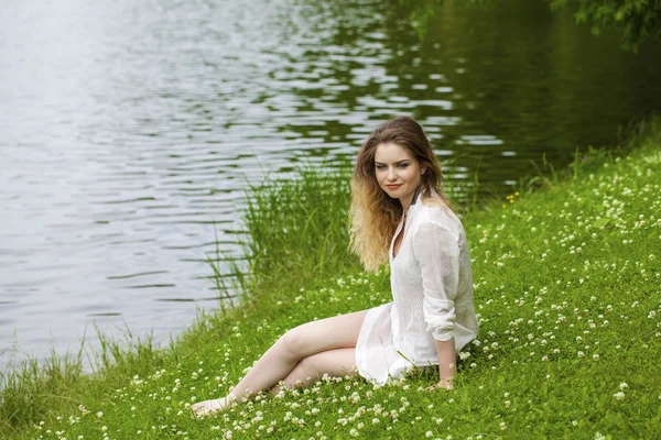 Giovane donna bionda sul prato verde — Foto Stock