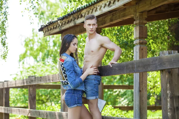 Muscular young man and sexy naked woman — Stock Photo, Image
