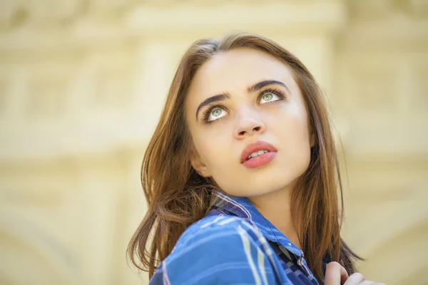 Close up of young beautiful woman in a checkered blue shirt — Stock Photo, Image