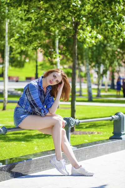 Young beautiful woman in a checkered blue shirt — Stock Photo, Image