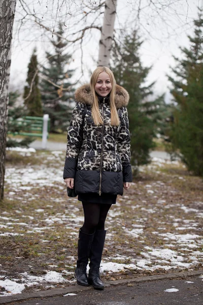 Happy young blonde woman on the background of a winter park — Stock Photo, Image