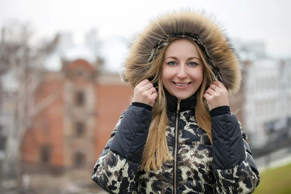 Young beautiful blonde woman in fur hood — Stock Photo, Image