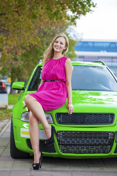 Ritratto di una bella donna bionda e auto sportiva verde — Foto Stock