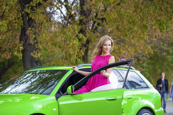 Portrait of a beautiful blonde woman and green sports car — Stock Image Portrait of a beautiful blonde woman and green sports car Stock Photo