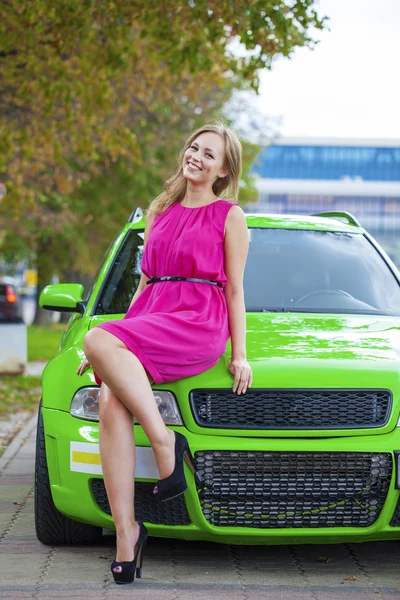 Portrait of a beautiful blonde woman and green sports car — Stock Image Portrait of a beautiful blonde woman and green sports car Stock Picture