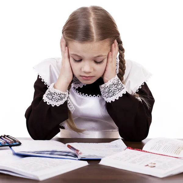 Sad schoolgirl sits at a school desk — Stock Photo, Image