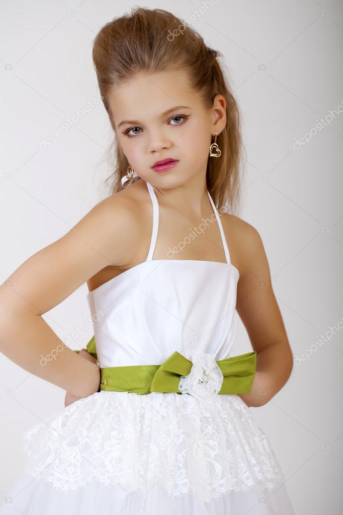 Portrait of a little girl in white classic dress 