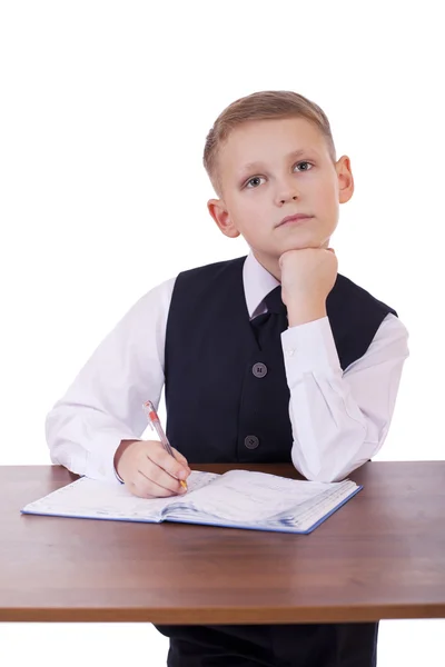 Caucasiano menino da escola em sua mesa em fundo branco com cópia s — Fotografia de Stock