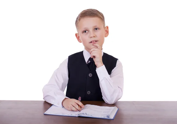 Caucasian school boy at his desk on white background with copy s — Stock Photo, Image