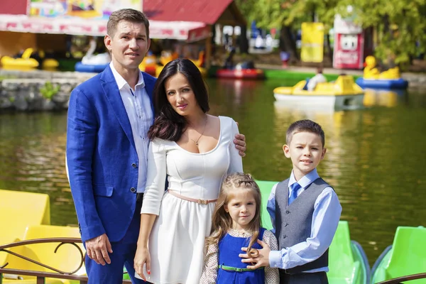 Young happy family portrait on background of the autumn park