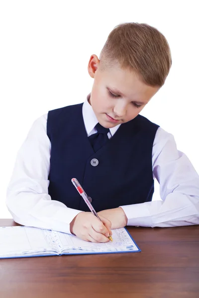 Caucasian school boy at his desk on white background with copy s — Stock Photo, Image