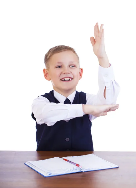 Caucasiano menino da escola em sua mesa em fundo branco com cópia s — Fotografia de Stock