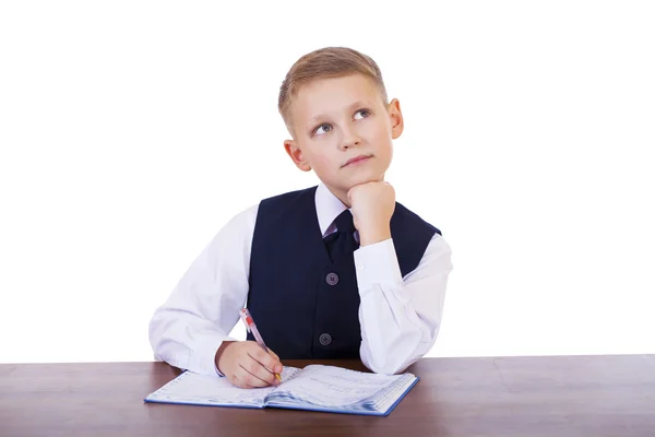 Kaukasische school jongen achter zijn Bureau op witte achtergrond met kopie s — Stockfoto