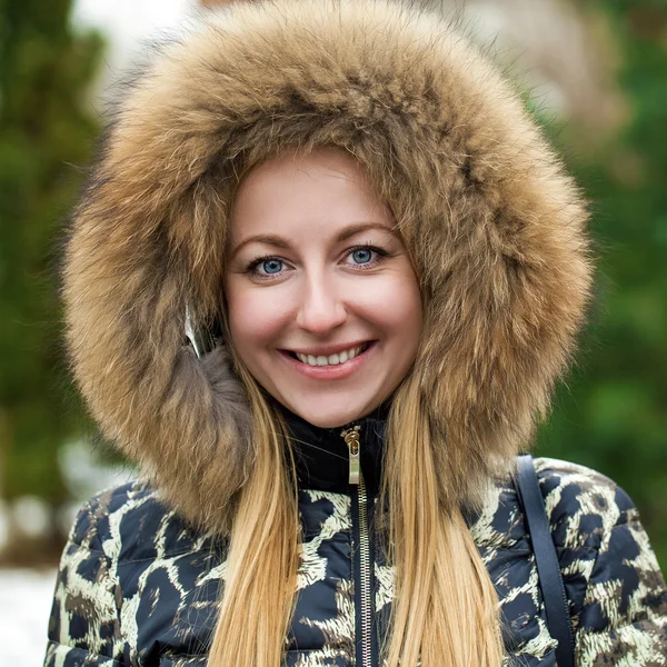 Young beautiful blonde woman in fur hood — Stock Photo, Image