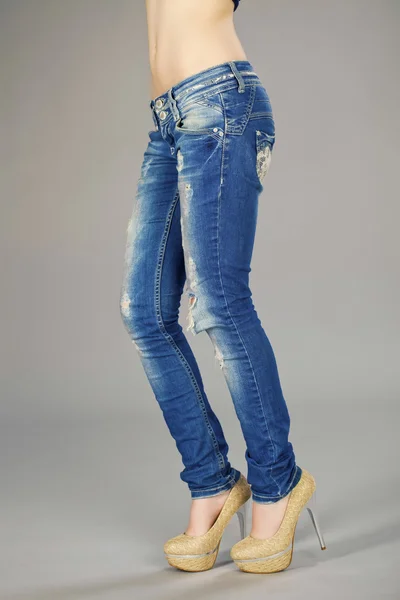 Lichaamsdeel, mooie vrouw dragen van jeans geïsoleerd op grijze backgr — Stockfoto