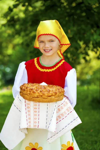 Little girl is dressed in the Russian national dress in summer p — Stock Photo, Image