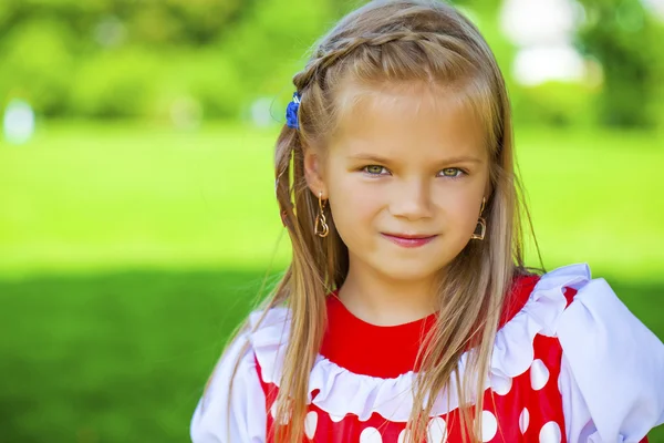 Portrait of a charming little girl looking at camera — Stock Photo, Image