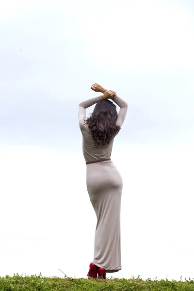 Young woman in sexy long gray dress — Stock Photo, Image