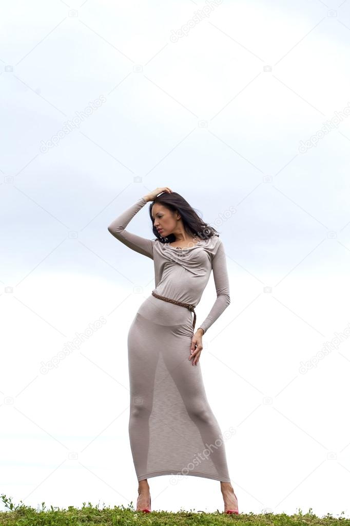 Young woman in sexy long gray dress 