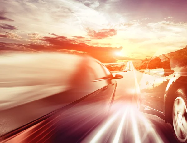 Motion blurred car on asphalt road — Stock Photo, Image