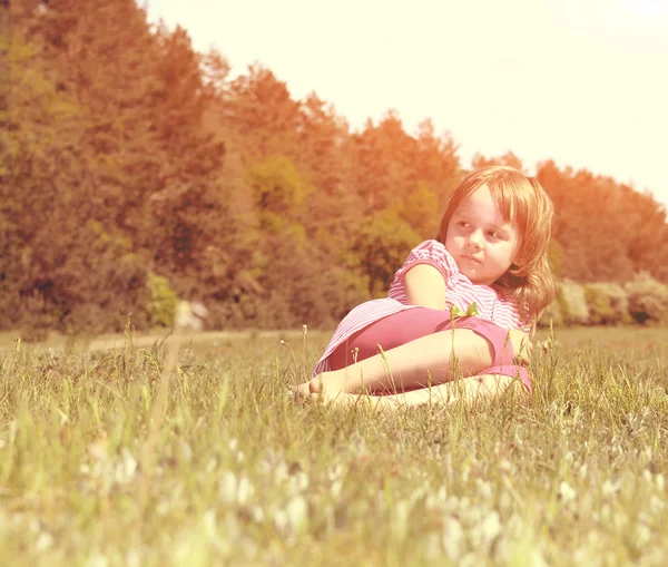 Adorable girl lying on grass — Stock Photo, Image