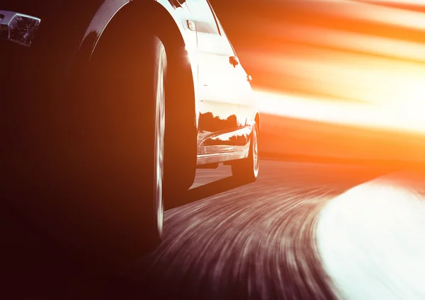 Speeding car through street — Stock Photo, Image