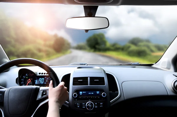 Driver's hands on steering wheel — Stock Photo, Image