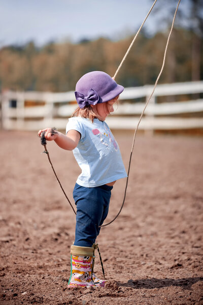 Cute little girl standing near a puddle