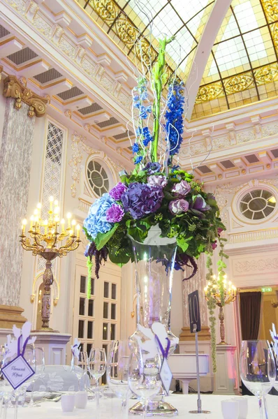 Table avec fleurs dans la salle de banquet — Photo