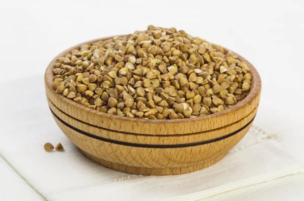 Buckwheat groats in wooden bowl — Stock Photo, Image