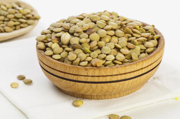 Lentil seeds in wooden bowl — Stock Photo, Image